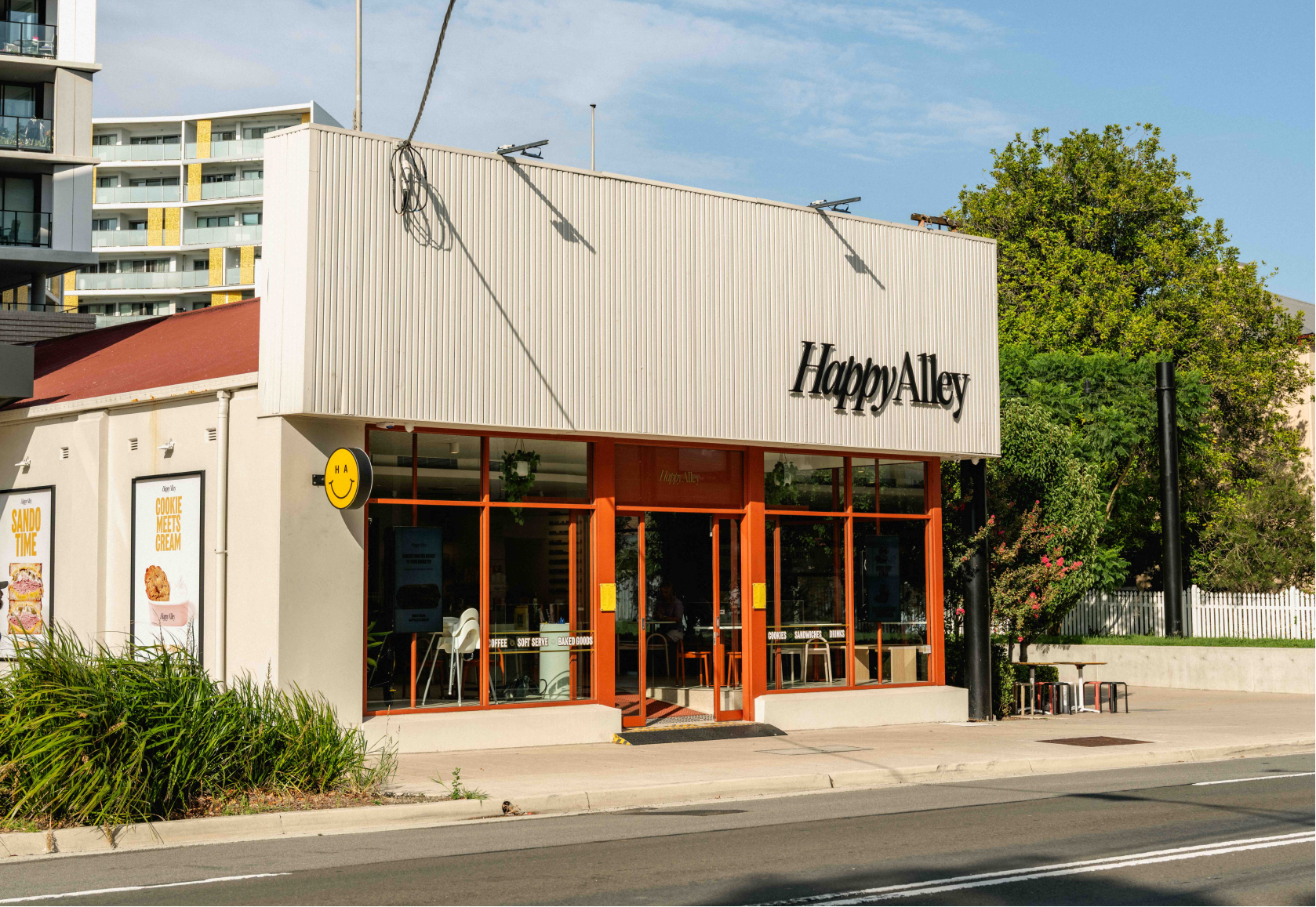 Happy Alley Cafe on a Bay Street with buildings and trees in the background