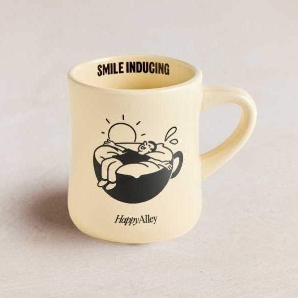 Beige mug with black illustrations and text on a light gray background